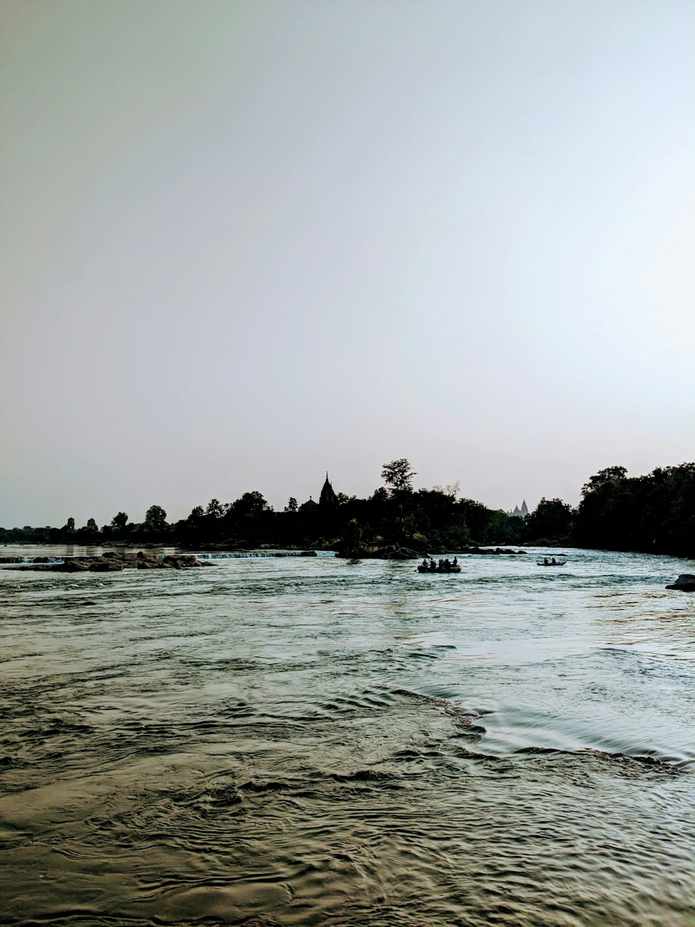 a body of water with boats floating on top of it