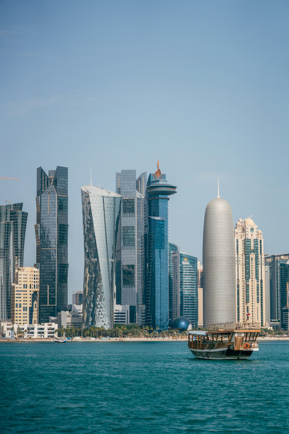 a boat in a body of water with a city in the background