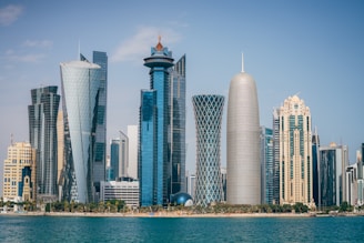 a group of tall buildings sitting next to a body of water