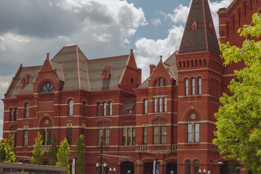 a large red brick building with a clock tower