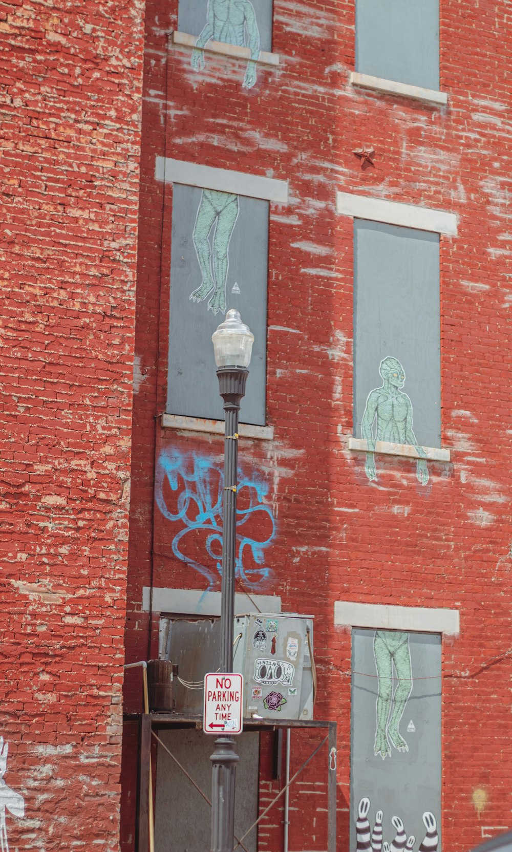 a red brick building with graffiti on the side of it
