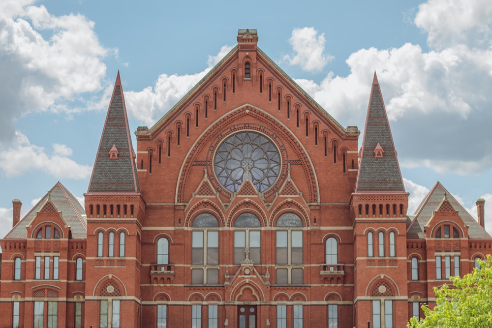 a large red brick building with a clock tower