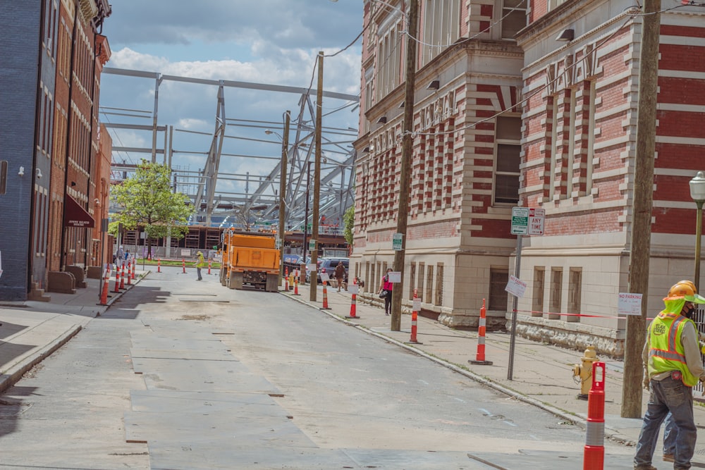 a construction worker standing on the side of a road