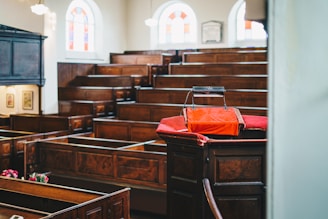 a church with wooden pews and stained glass windows