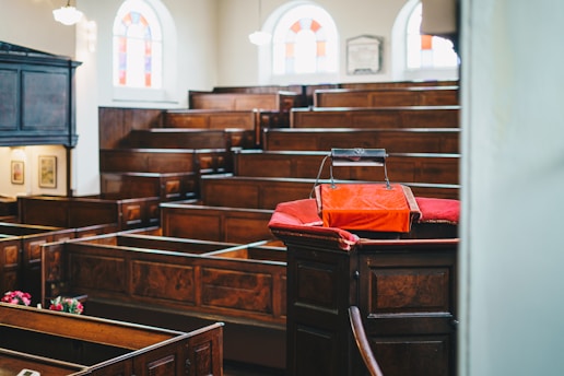 a church with wooden pews and stained glass windows