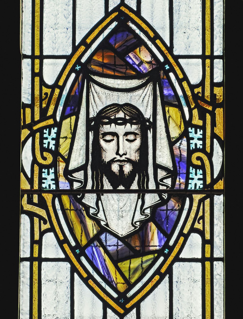 a stained glass window with a picture of jesus