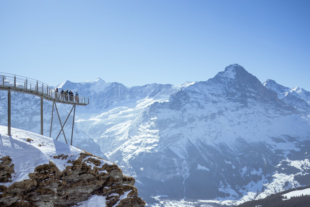 a group of people standing on top of a snow covered mountain