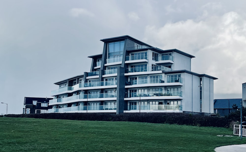 a very tall building sitting on top of a lush green field