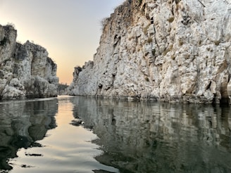 a body of water surrounded by rocky cliffs