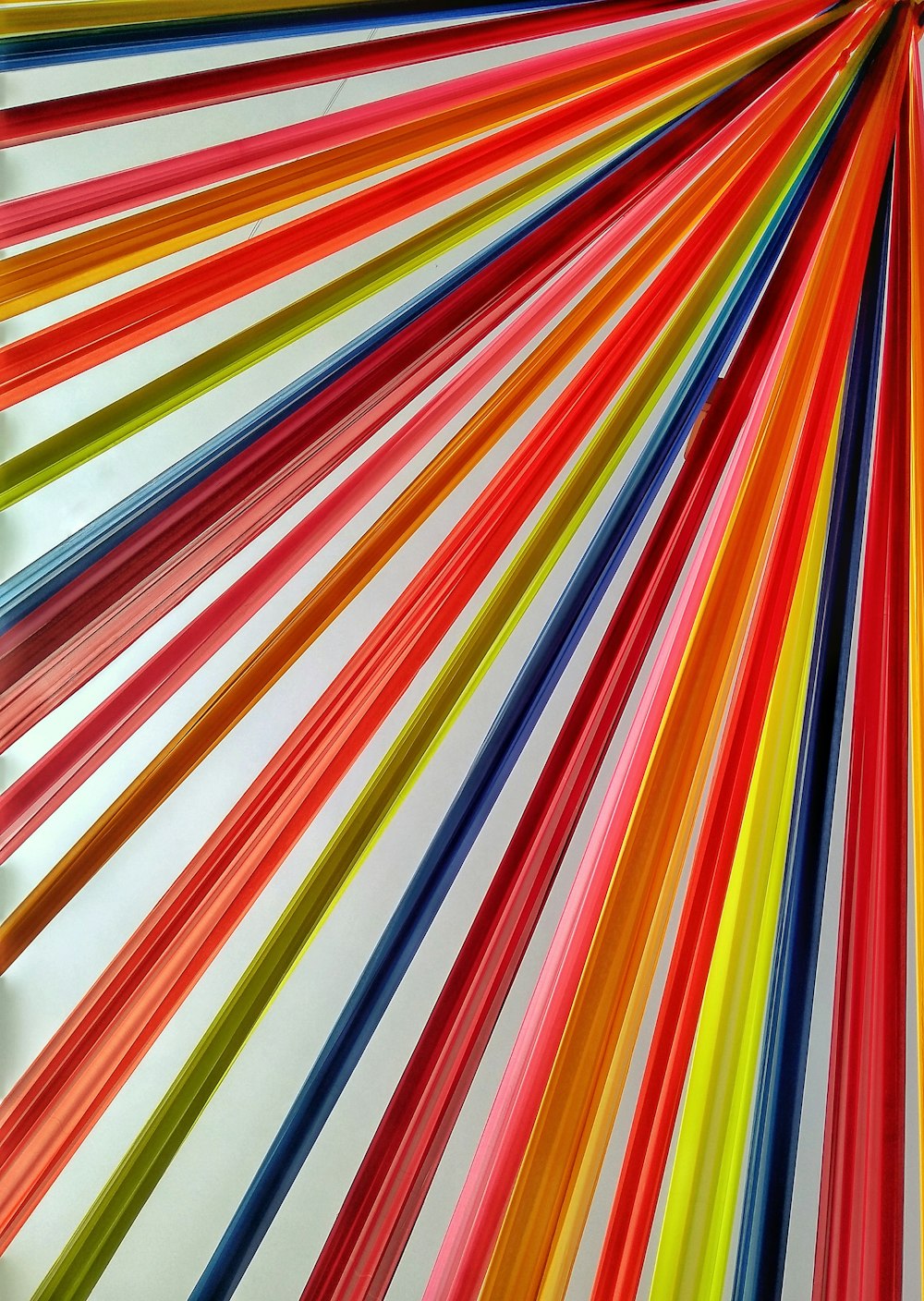 a large group of colored sticks in a room