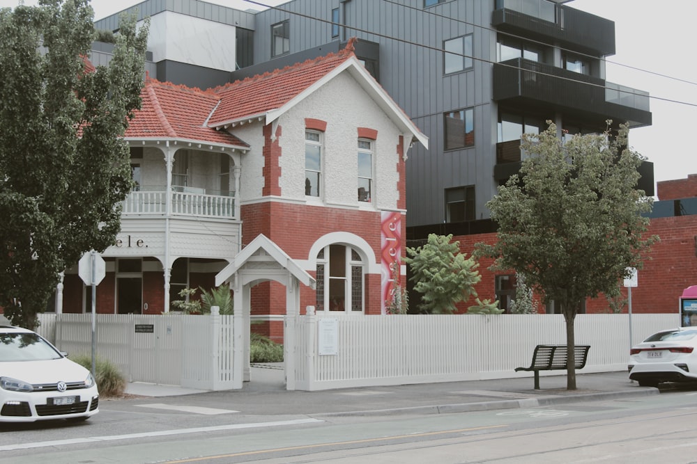 a red and white house on a street corner