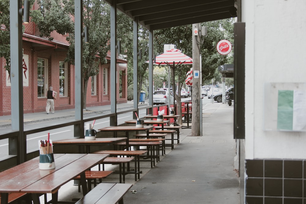 a row of tables sitting on the side of a street