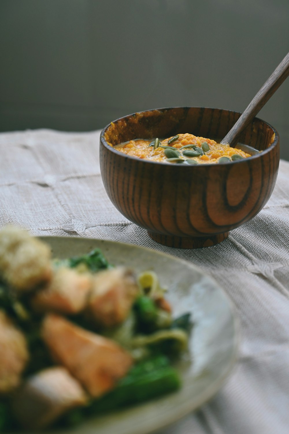 a bowl of food and a plate of food on a table