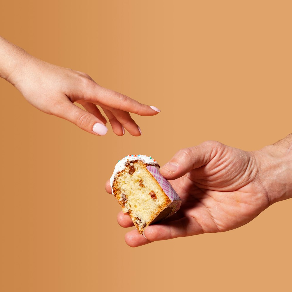 a hand holding a piece of food