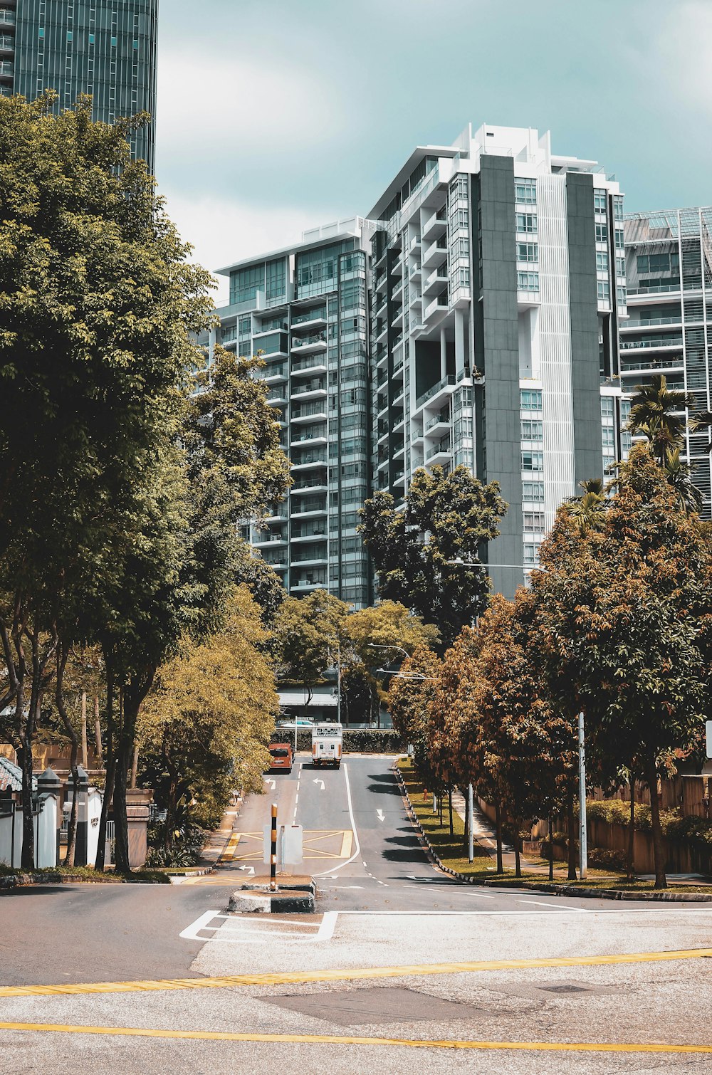 a city street with tall buildings in the background