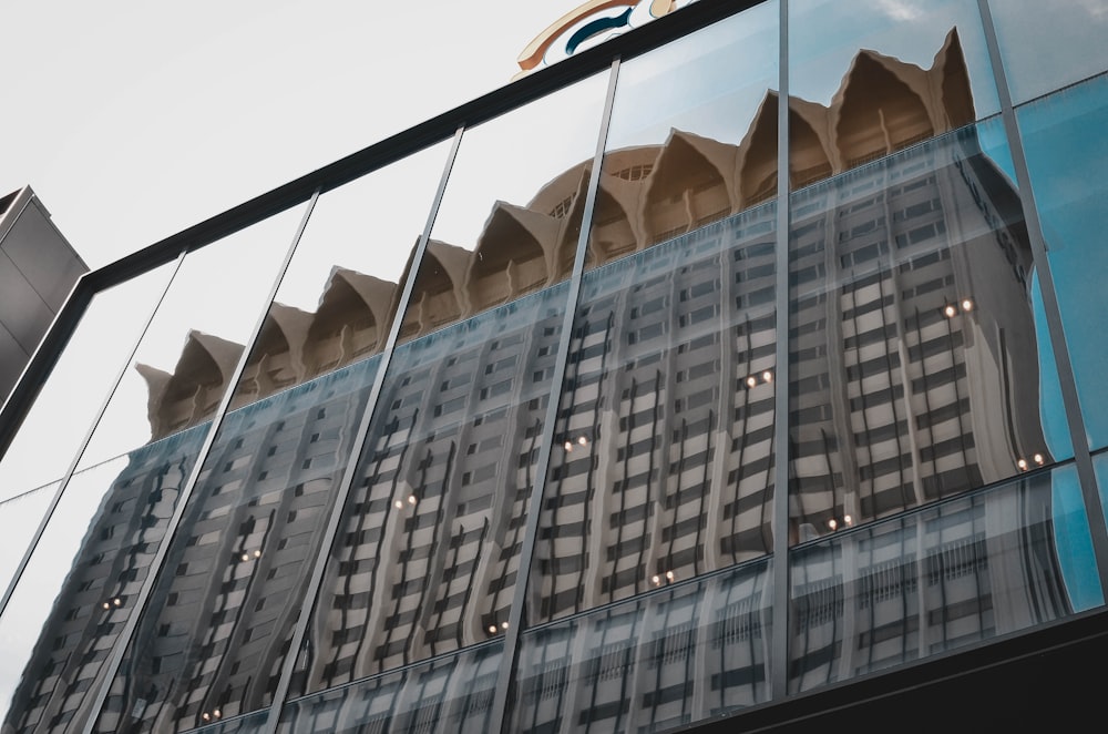 a reflection of a building in a glass window