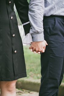 a close up of two people holding hands