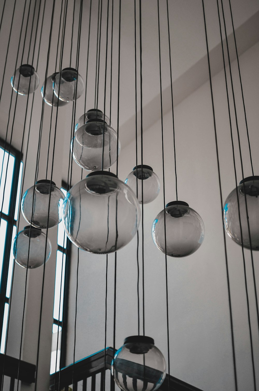 a bunch of glass balls hanging from a ceiling