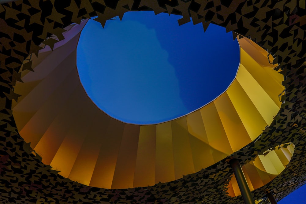 a blue sky is reflected in a circular mirror