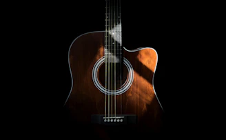 a close up of an acoustic guitar on a black background