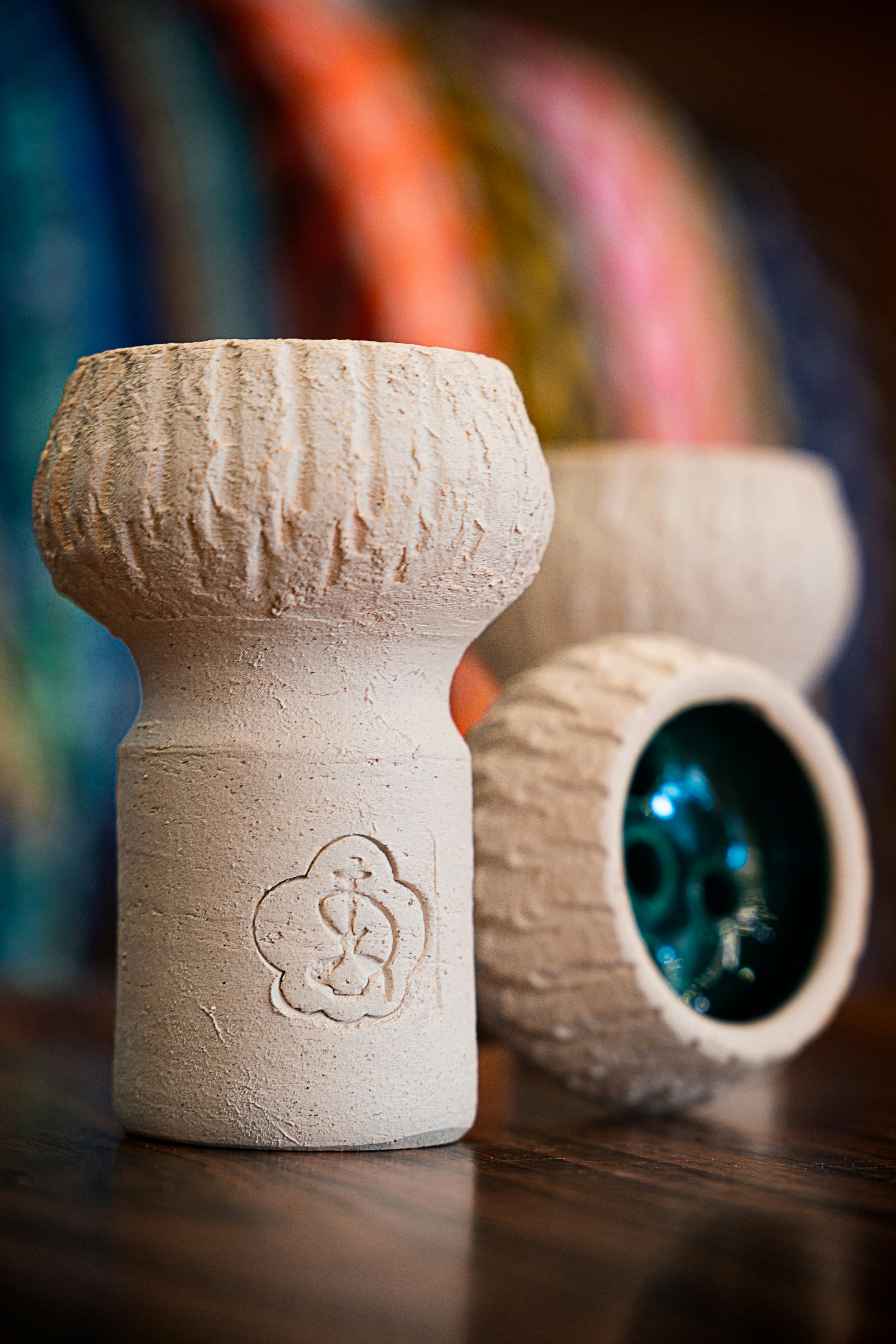 a couple of white vases sitting on top of a wooden table