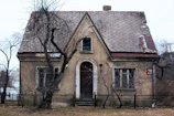 an old house with a fence around it