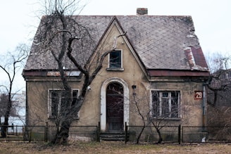 an old house with a fence around it