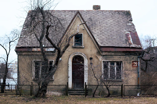 an old house with a fence around it