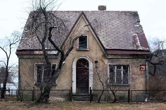 an old house with a fence around it