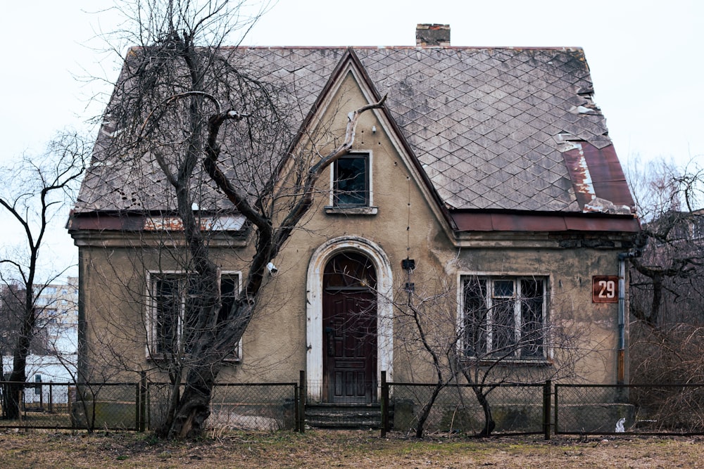 an old house with a fence around it