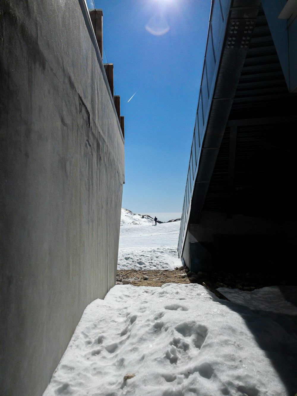 a snowboarder is going down a ramp in the snow