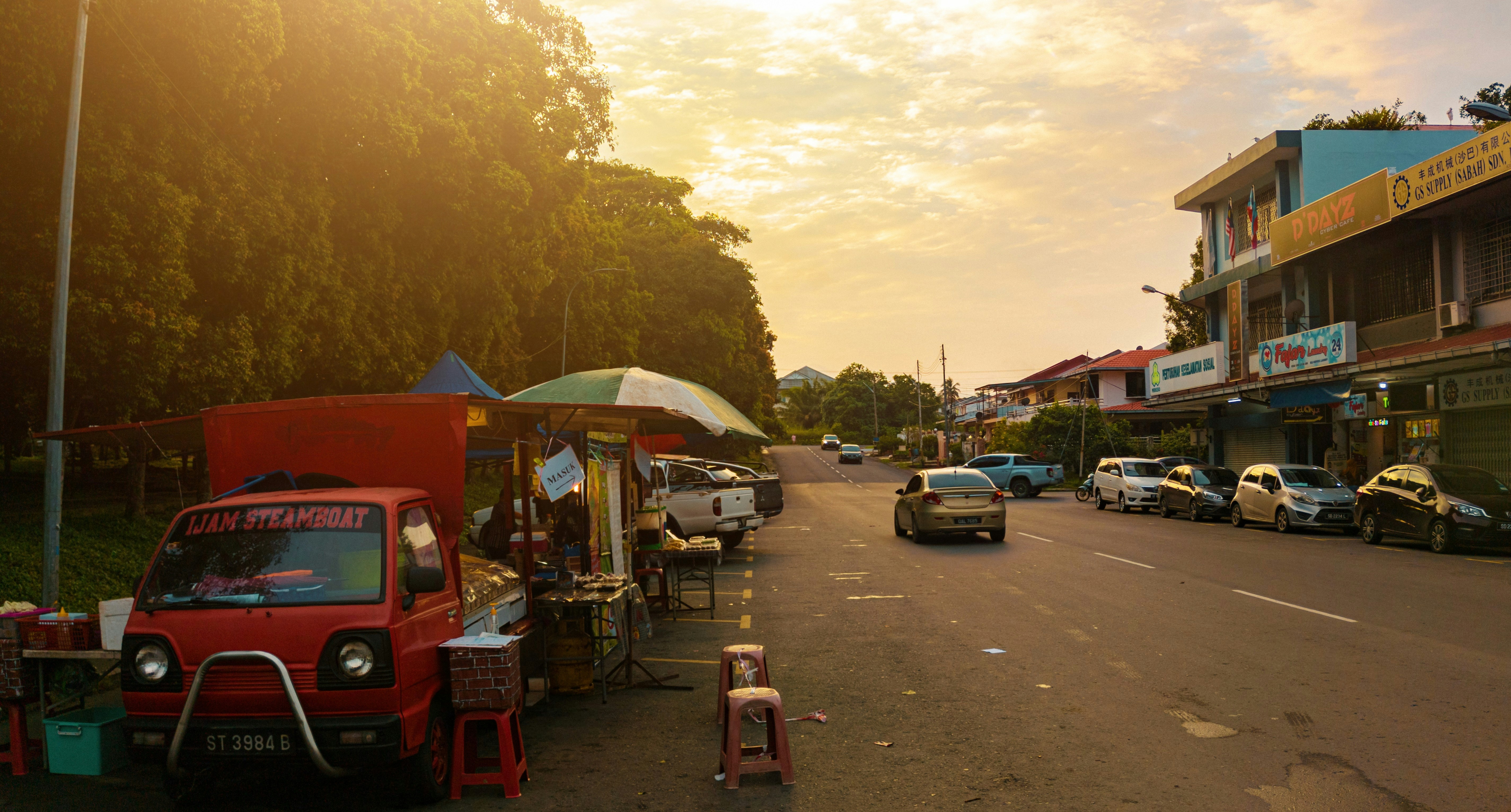 a street scene with cars parked on the side of the road