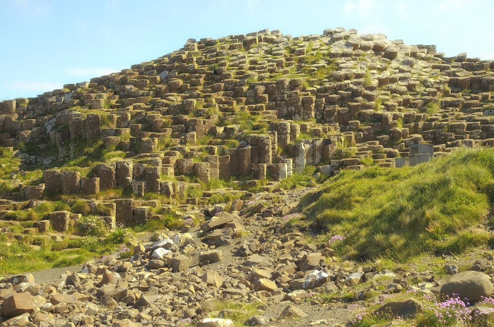 a rocky hill covered in grass and rocks