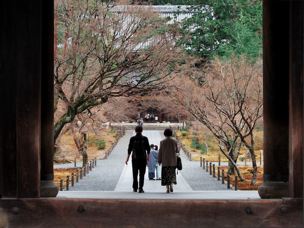 a man and a woman walking down a walkway