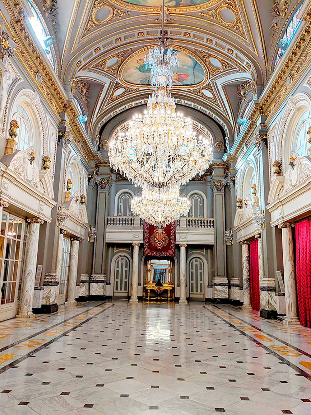 a chandelier hanging from the ceiling of a large room