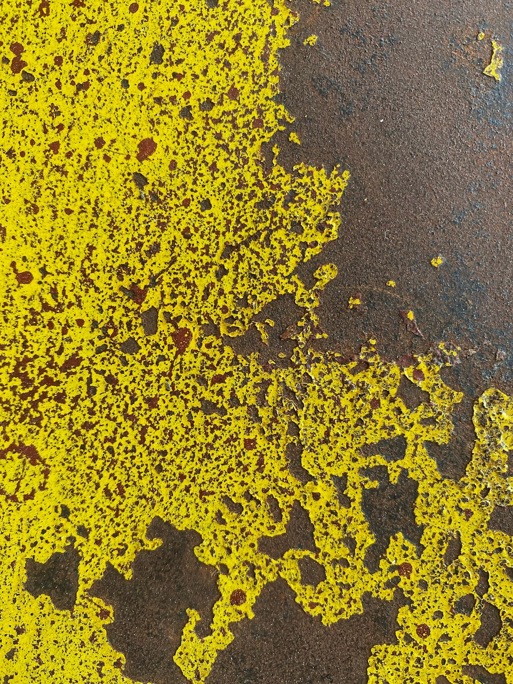 a close up of yellow paint on the ground