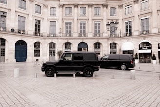 a black truck parked in front of a large building