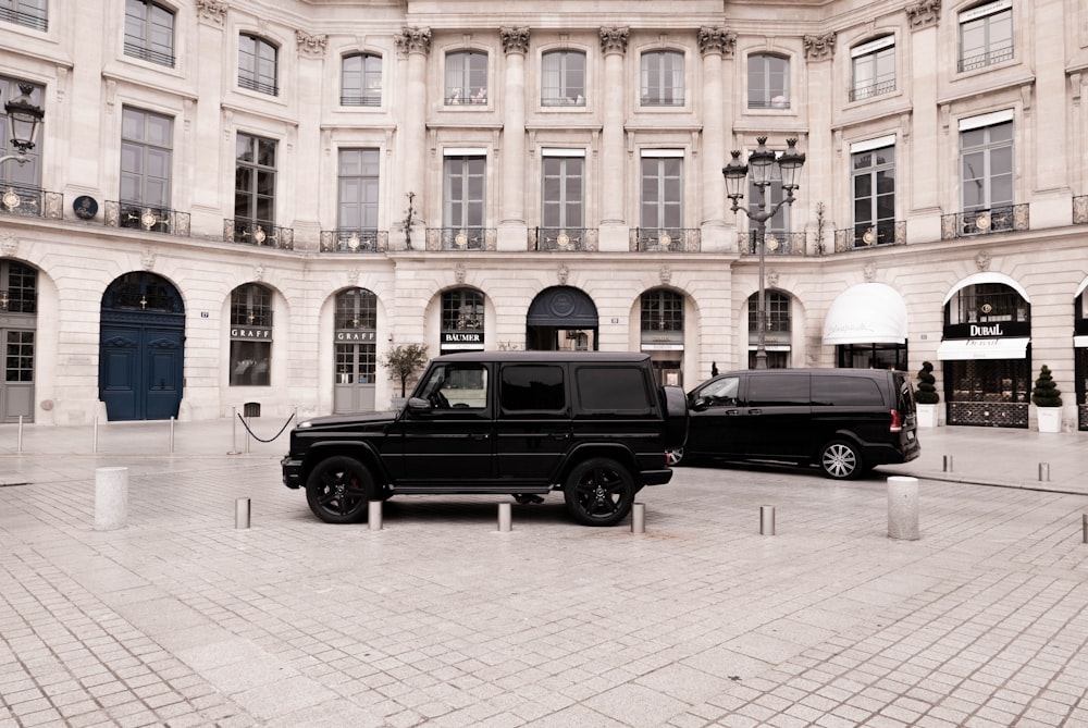 a black truck parked in front of a large building