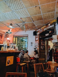 a group of people sitting at a table in a restaurant