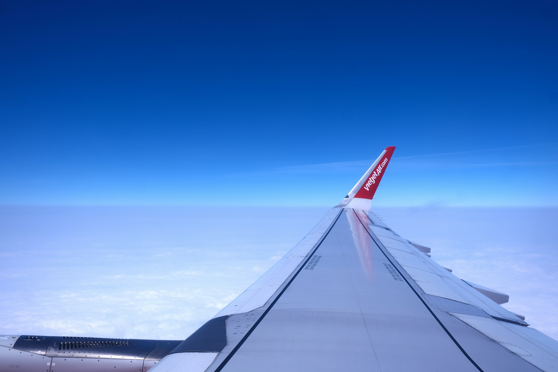 a view of the wing of an airplane in the sky