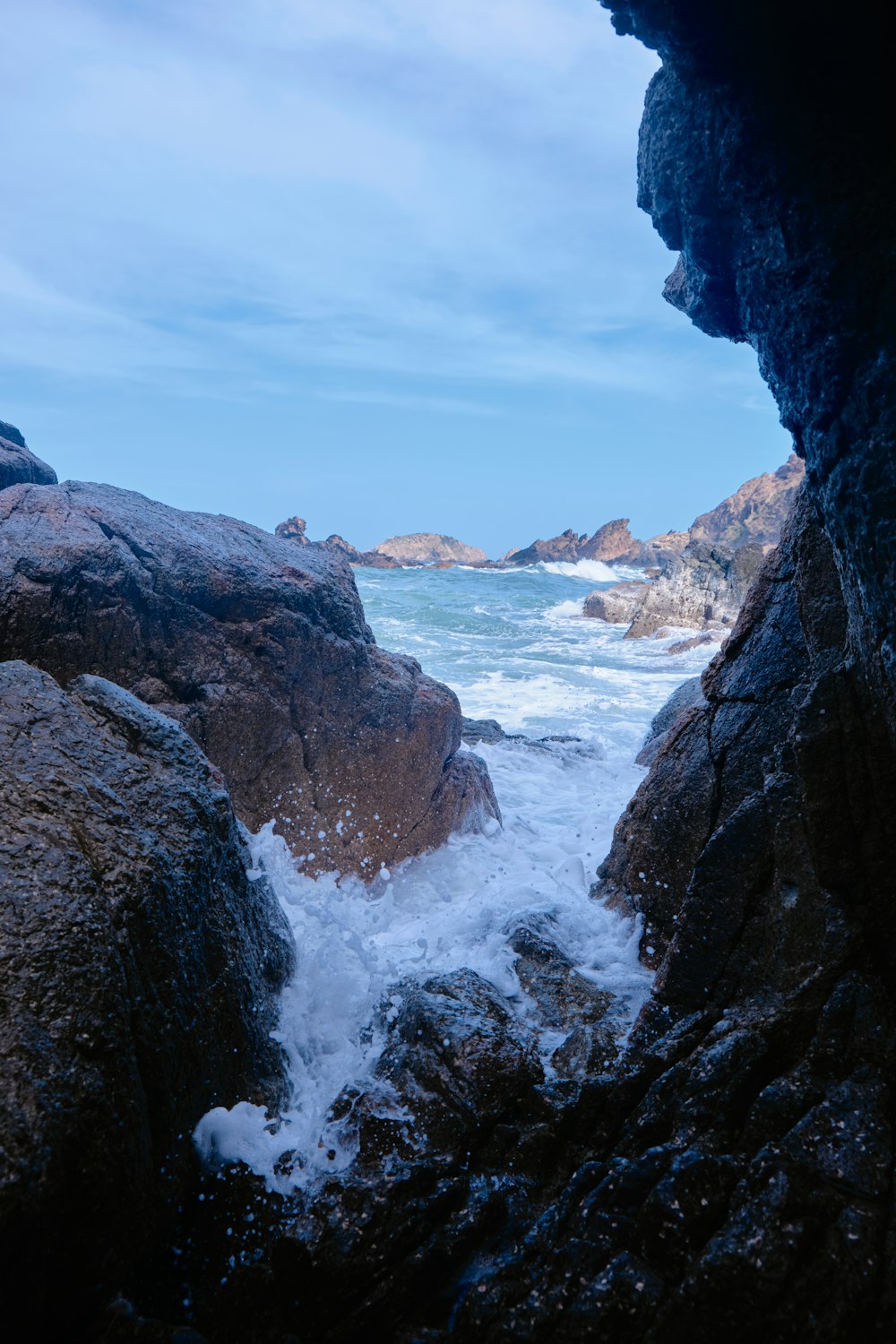 a view of the ocean from inside a cave