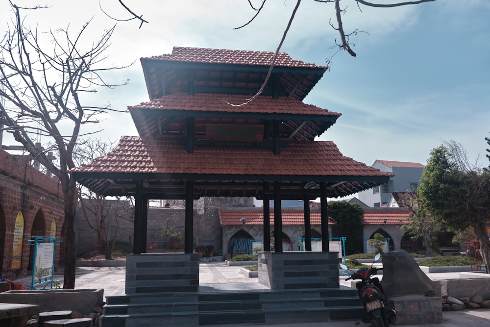 a small pavilion with a motorcycle parked in front of it