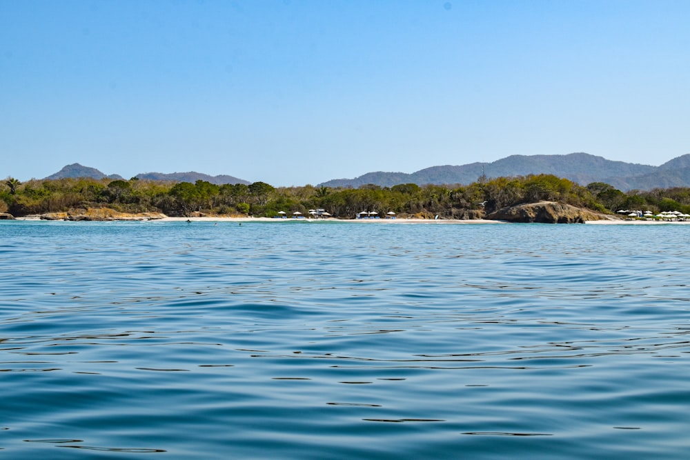 a body of water with mountains in the background