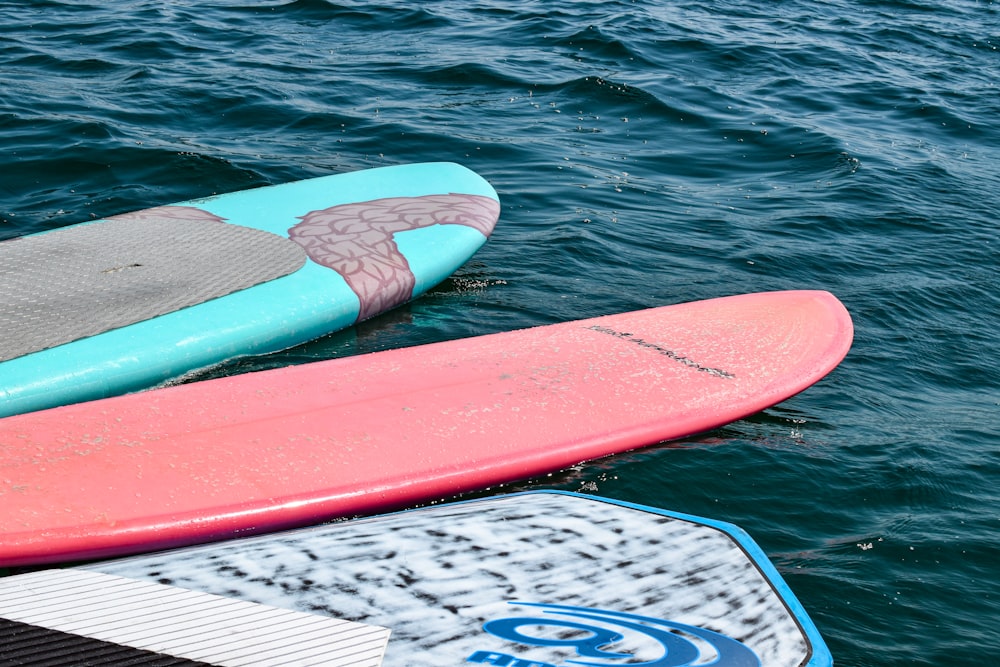 a couple of surfboards sitting on top of a body of water