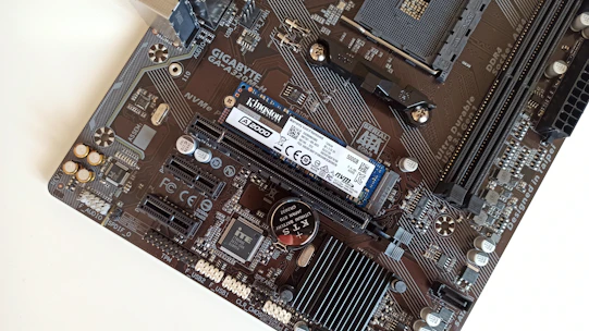 Close-up of a high-performance server motherboard with NVMe SSDs and dual Xeon CPUs.