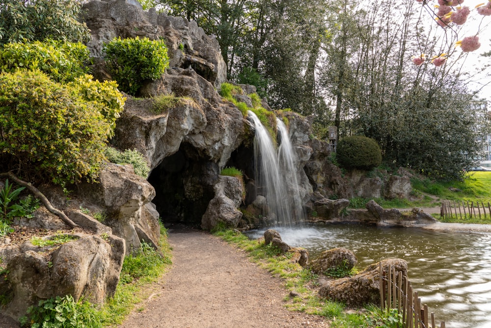 a small waterfall is coming out of a cave