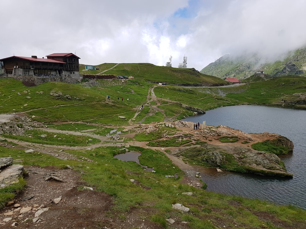 a house on a hill with a lake in the foreground