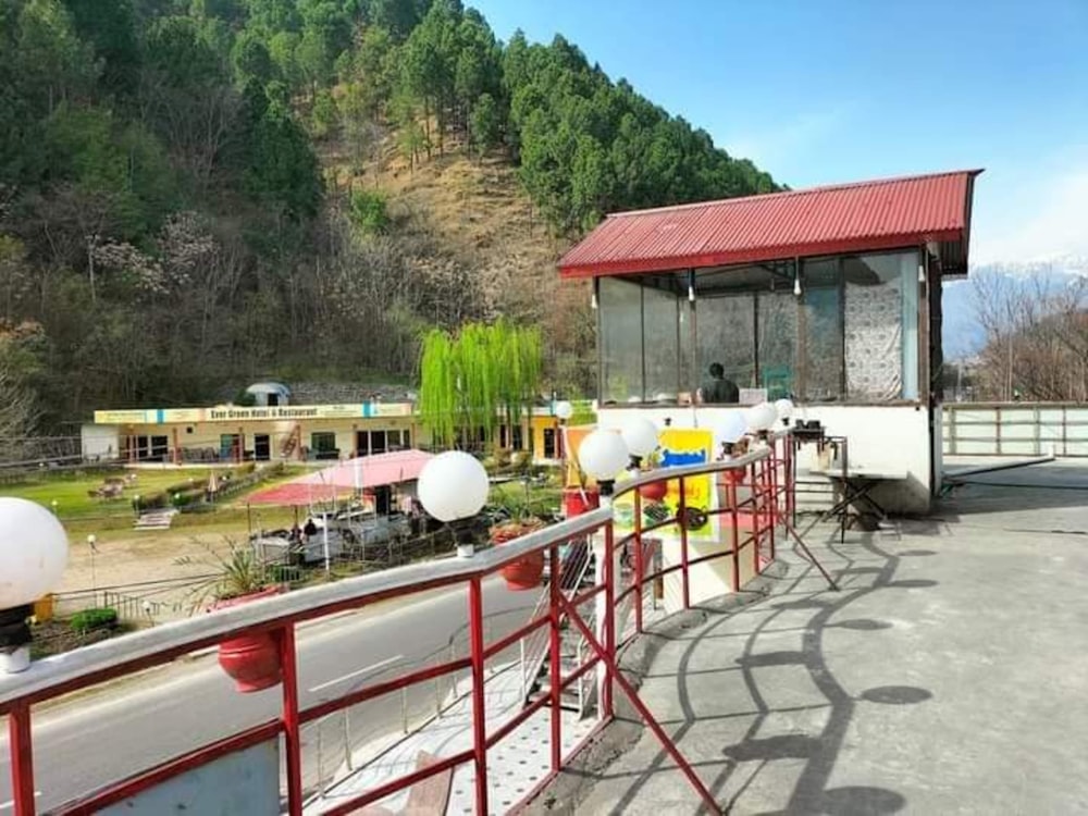 a red and white building sitting on the side of a road