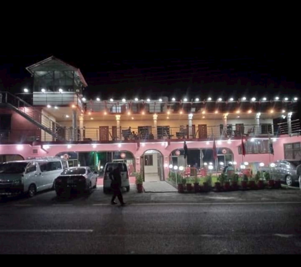 a pink building with lights on it at night