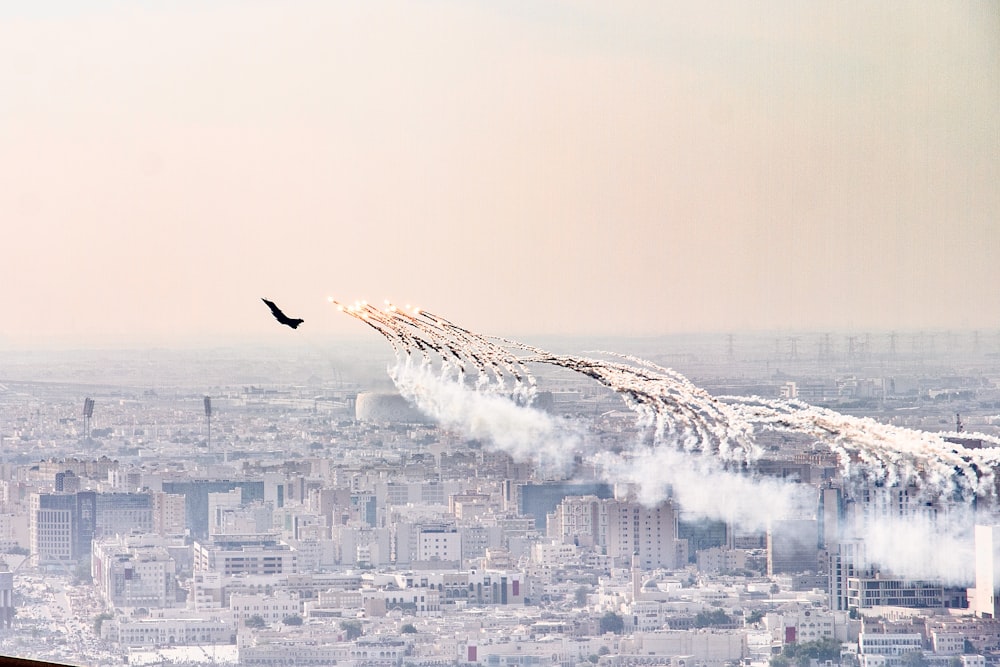 a group of airplanes flying over a city